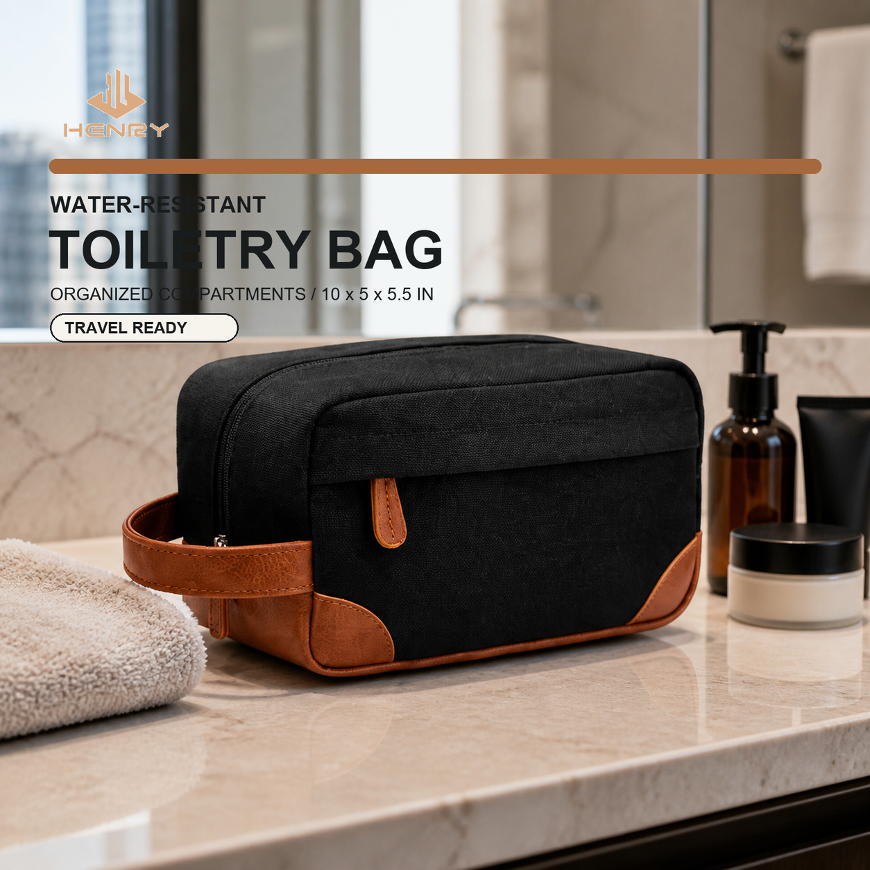 Black canvas travel toiletry bag with brown PU trim in a hotel bathroom setting