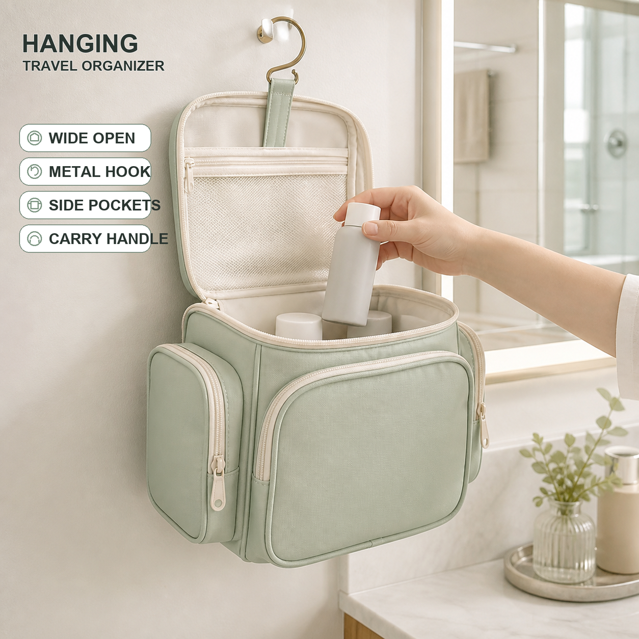 Custom Hanging Toiletry Organizer with Wet Pocket Sage-green hanging toiletry organizer open in a bathroom with mesh pockets, elastic bottle loops, side pockets, a metal hook and carry handle