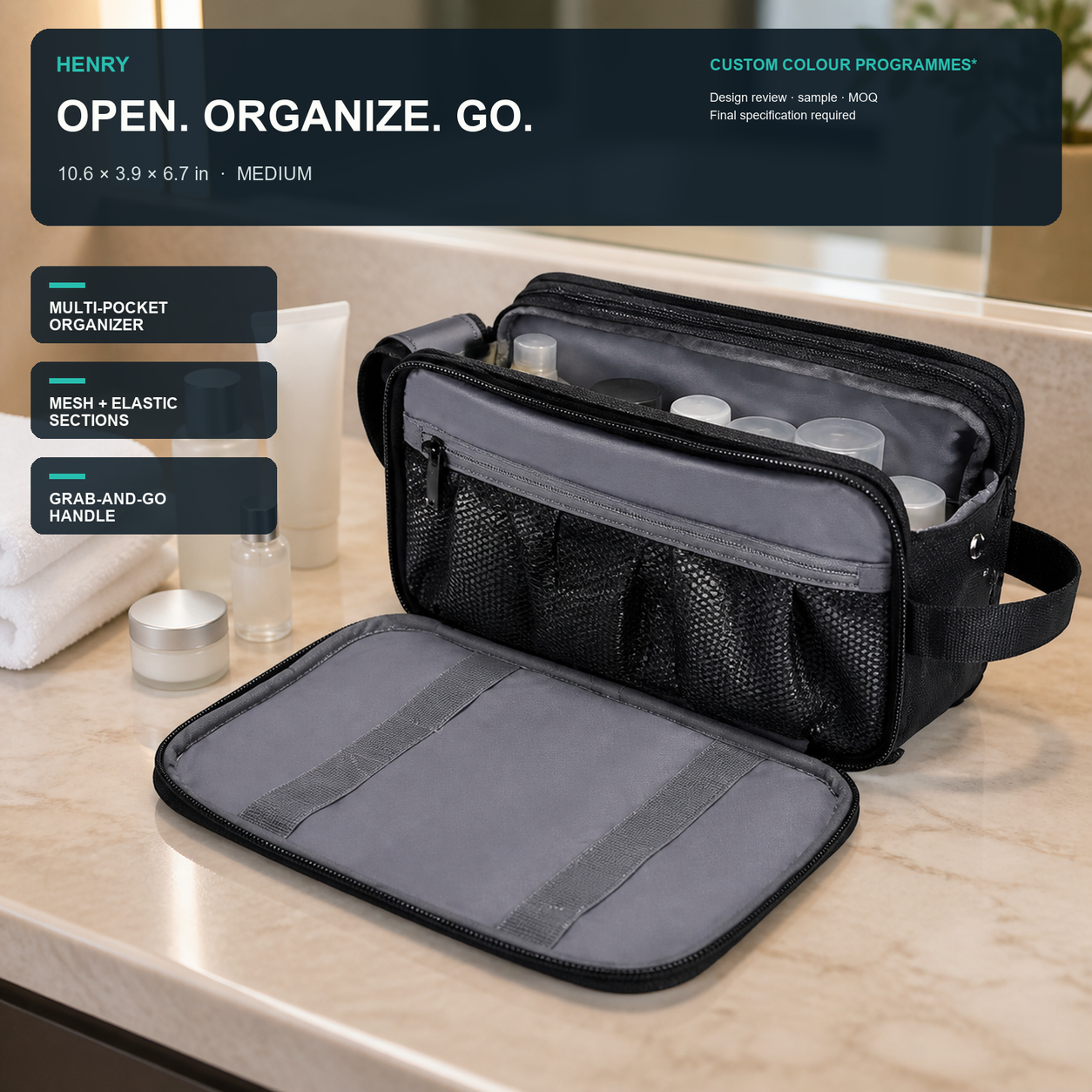 HENRY GOOD Custom Medium Multi-Pocket Toiletry Organizer Black medium multi-pocket toiletry organizer open on a hotel vanity with grey lining, mesh sections, elastic retainers, and side grab handle